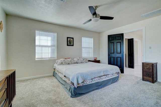 bedroom with carpet floors, visible vents, baseboards, and a ceiling fan