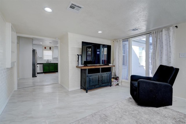 living area with recessed lighting, marble finish floor, visible vents, and a textured ceiling