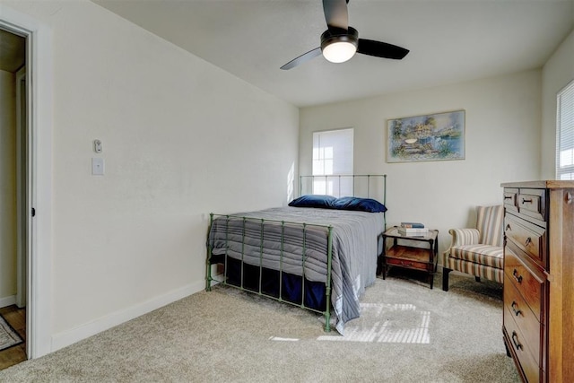 carpeted bedroom featuring a ceiling fan and baseboards