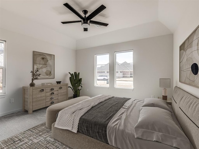 bedroom with a ceiling fan, lofted ceiling, light colored carpet, and baseboards