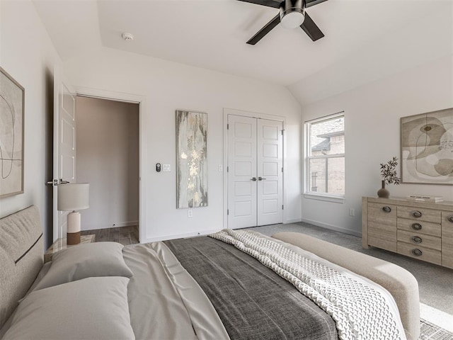 bedroom featuring carpet floors, a closet, vaulted ceiling, ceiling fan, and baseboards