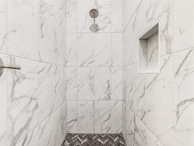 bathroom with tiled shower