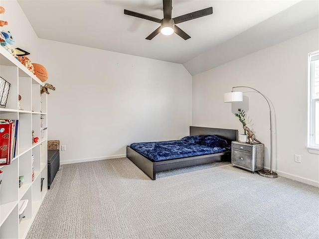 bedroom featuring vaulted ceiling, carpet floors, multiple windows, and baseboards