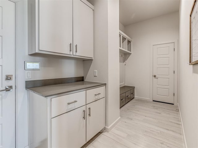 mudroom featuring light wood-type flooring and baseboards