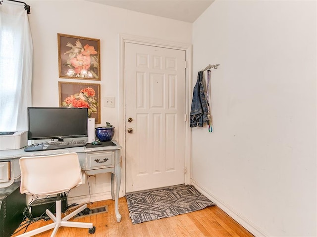 office with baseboards and light wood finished floors