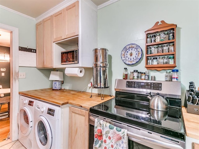 kitchen with electric range, light brown cabinets, wooden counters, and independent washer and dryer