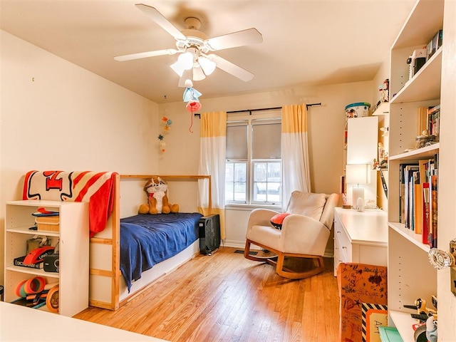 bedroom with hardwood / wood-style flooring and a ceiling fan