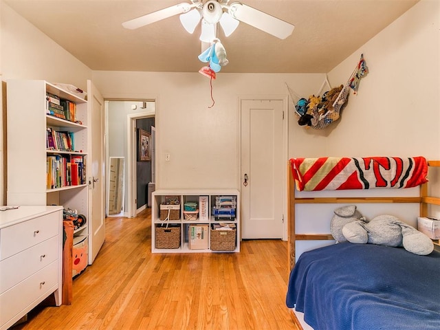 bedroom with light wood-type flooring and a ceiling fan