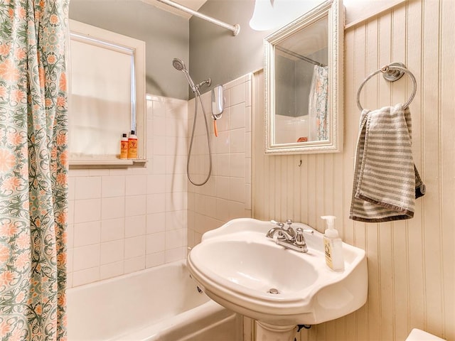 bathroom featuring a sink and shower / bathtub combination with curtain