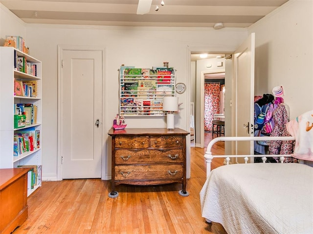 bedroom with light wood finished floors, ceiling fan, and crown molding