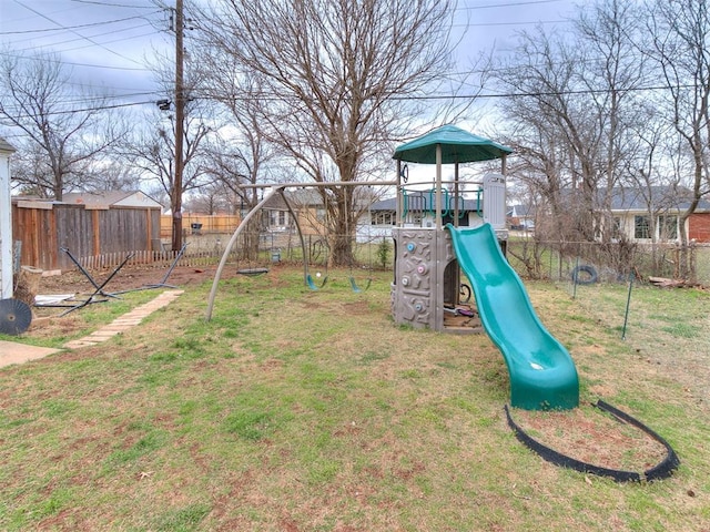 view of playground with a yard and a fenced backyard