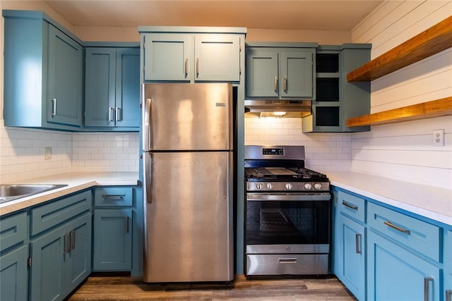 kitchen with stainless steel appliances, light countertops, under cabinet range hood, and open shelves