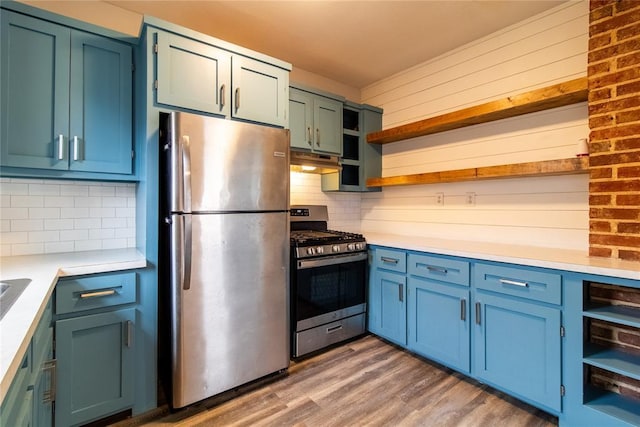 kitchen featuring open shelves, light countertops, appliances with stainless steel finishes, wood finished floors, and under cabinet range hood