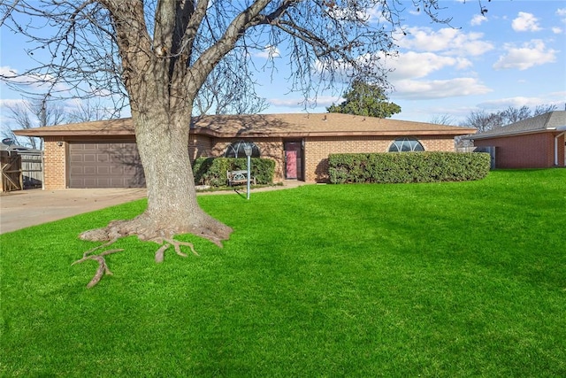 single story home with a garage, brick siding, concrete driveway, and a front yard