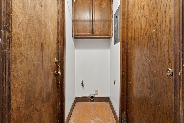 laundry area with tile patterned floors, baseboards, cabinet space, and hookup for an electric dryer