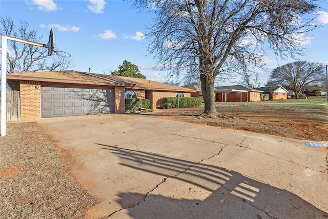 ranch-style home featuring brick siding, driveway, and a garage