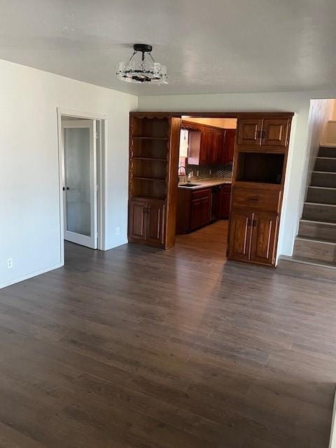 interior space featuring dark wood-style floors, stairway, and a sink