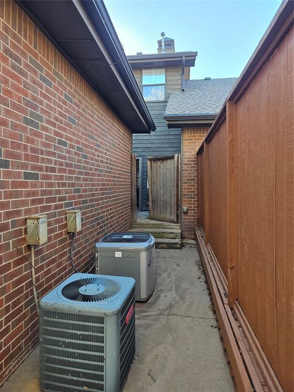 view of patio with central AC unit and fence