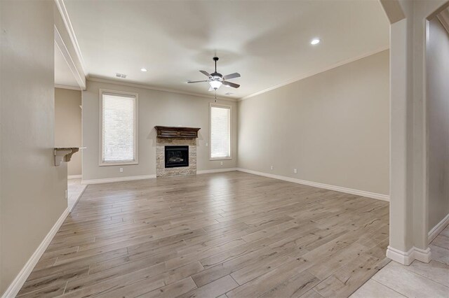 unfurnished living room featuring ceiling fan, baseboards, light wood-style floors, and ornamental molding