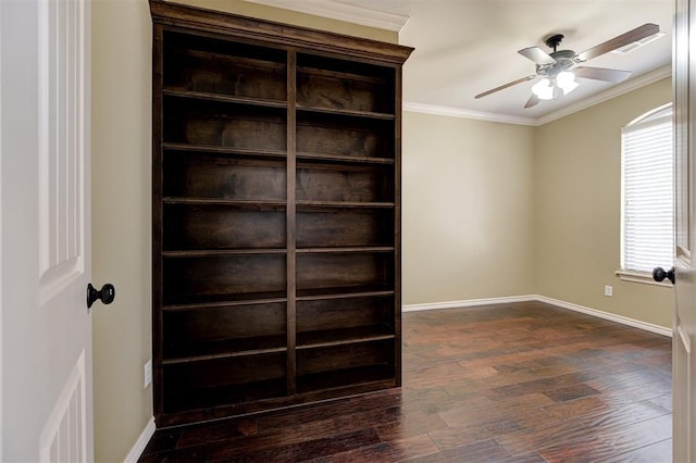 unfurnished room with a ceiling fan, visible vents, baseboards, ornamental molding, and dark wood-type flooring