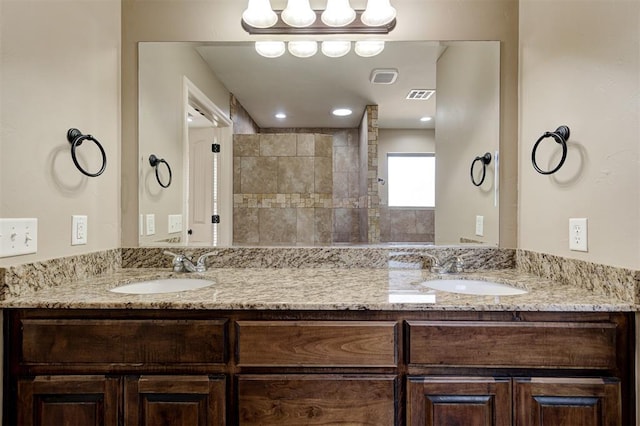 bathroom featuring double vanity, visible vents, and a sink