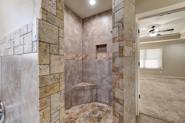 bathroom featuring tiled shower and a ceiling fan