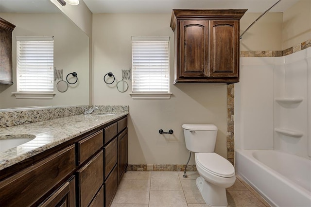 full bathroom with a sink, toilet, a wealth of natural light, and tile patterned floors