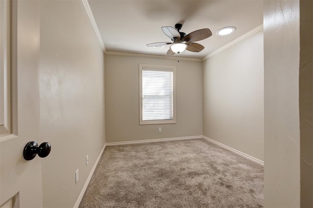 unfurnished room with baseboards, carpet, ornamental molding, and a ceiling fan