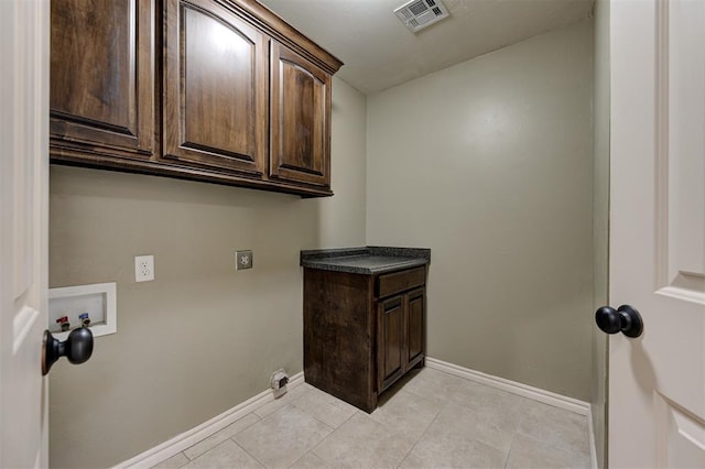 laundry area featuring visible vents, cabinet space, hookup for a washing machine, and baseboards