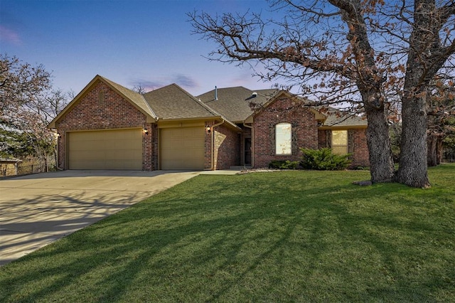 view of front of house featuring a front yard, brick siding, and a garage