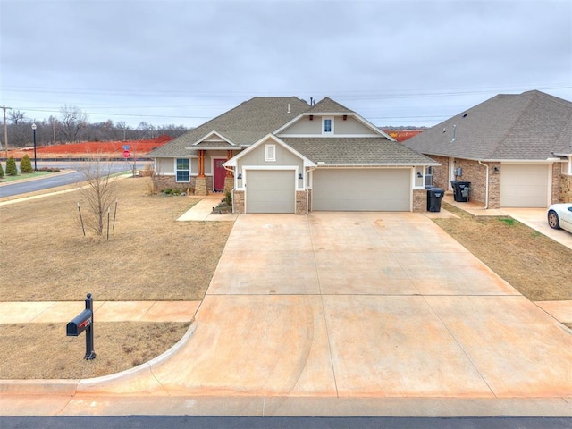 view of front of home featuring driveway, roof with shingles, an attached garage, and board and batten siding