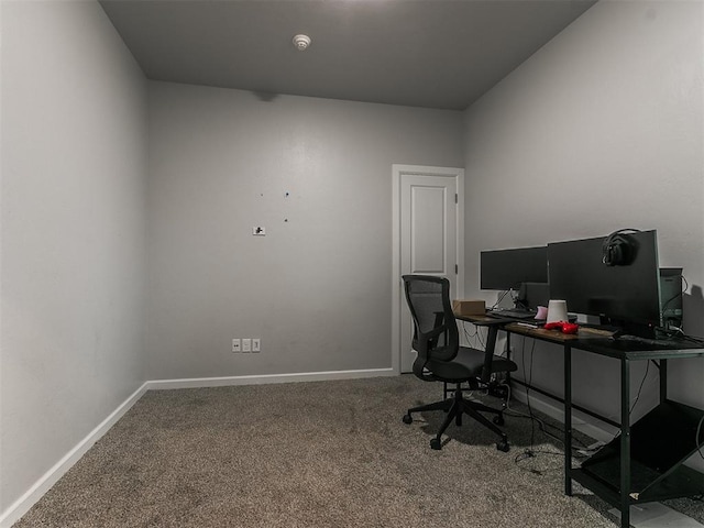 carpeted office featuring baseboards