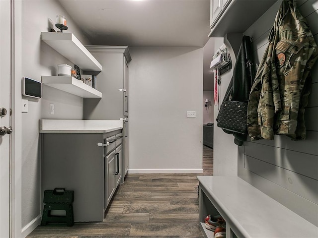 interior space with dark wood-type flooring and baseboards