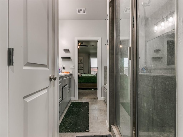 full bath with visible vents, connected bathroom, tile patterned floors, vanity, and a shower stall