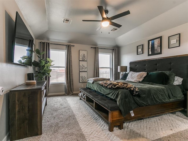 bedroom with light carpet, vaulted ceiling, visible vents, and baseboards