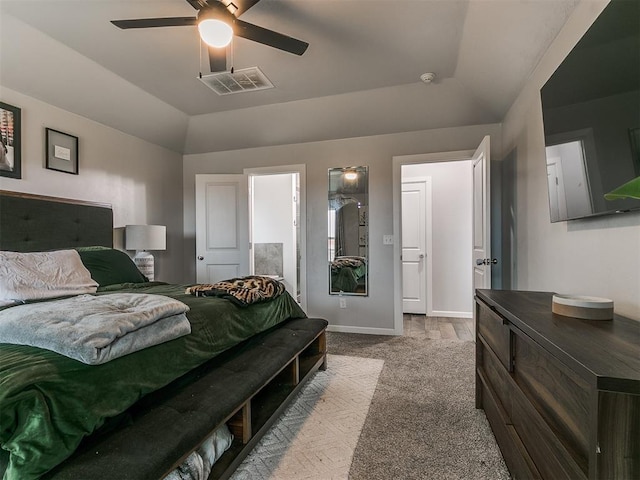 bedroom with vaulted ceiling, ceiling fan, visible vents, and baseboards