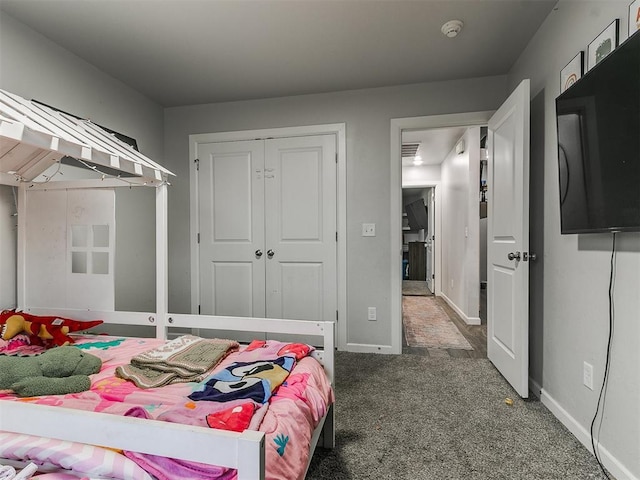 bedroom featuring carpet, baseboards, and a closet