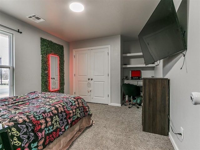 bedroom featuring carpet, a closet, visible vents, and baseboards