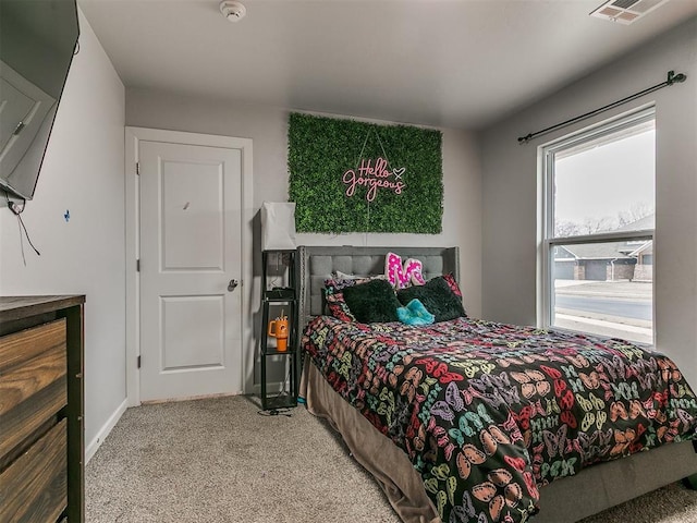 carpeted bedroom with baseboards and visible vents