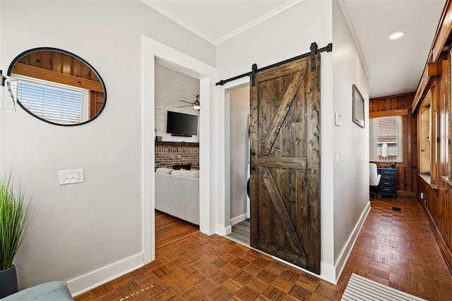 hallway featuring crown molding, a barn door, recessed lighting, and baseboards