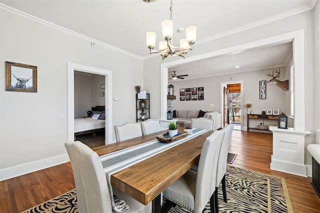 dining area with baseboards, ornamental molding, wood finished floors, and ceiling fan with notable chandelier