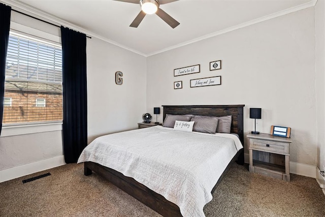 carpeted bedroom with a ceiling fan, baseboards, visible vents, and crown molding