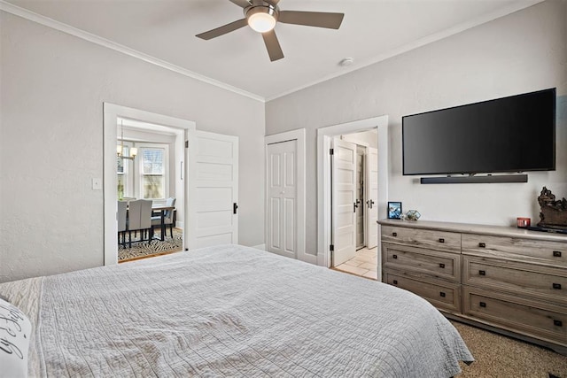 bedroom with ornamental molding, a ceiling fan, and ensuite bathroom