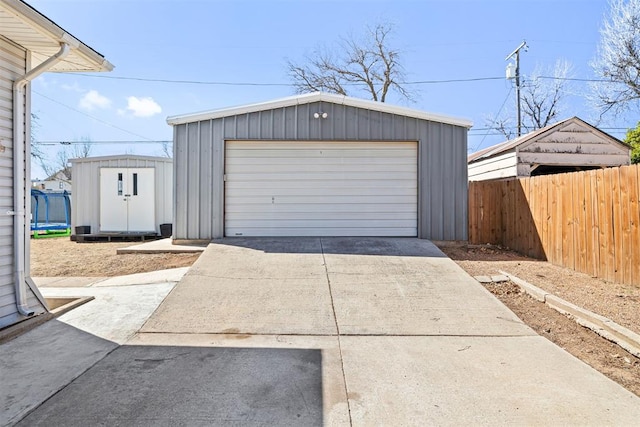 detached garage featuring fence