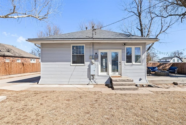 rear view of house featuring a fire pit, a patio area, fence, and entry steps