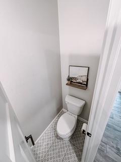 bathroom with toilet and baseboards