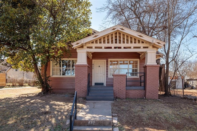 craftsman-style house with brick siding