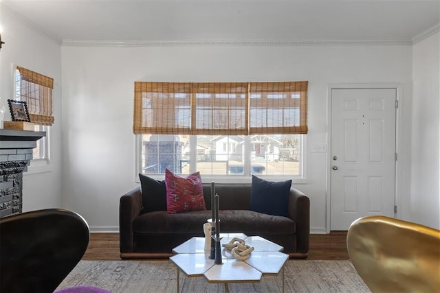 living room with ornamental molding, baseboards, and wood finished floors