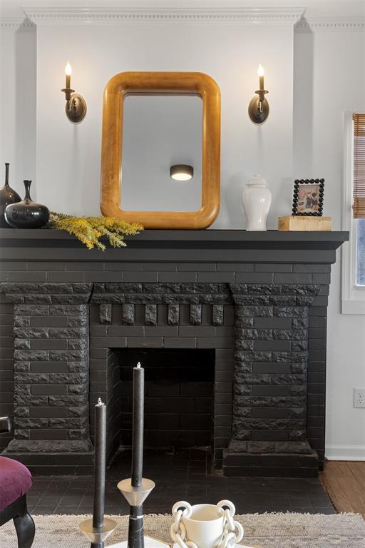 details with ornamental molding, a fireplace with flush hearth, and baseboards