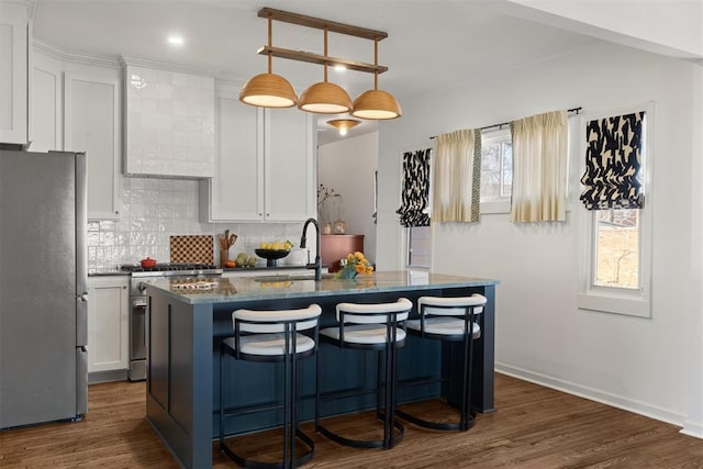 kitchen with appliances with stainless steel finishes, dark wood-type flooring, white cabinetry, and tasteful backsplash